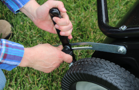 Close up of adjustable brush lever for lawn sweeper